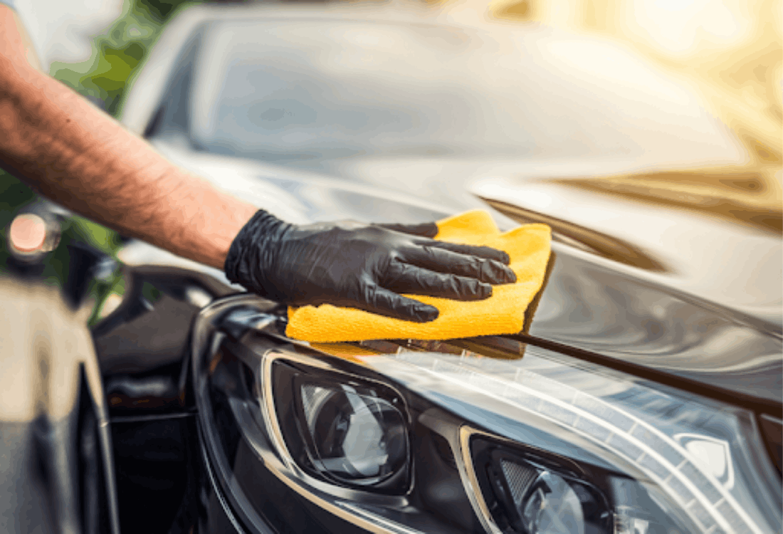 A man uses professional car cleaning chemicals from a supplier to clean his car. 