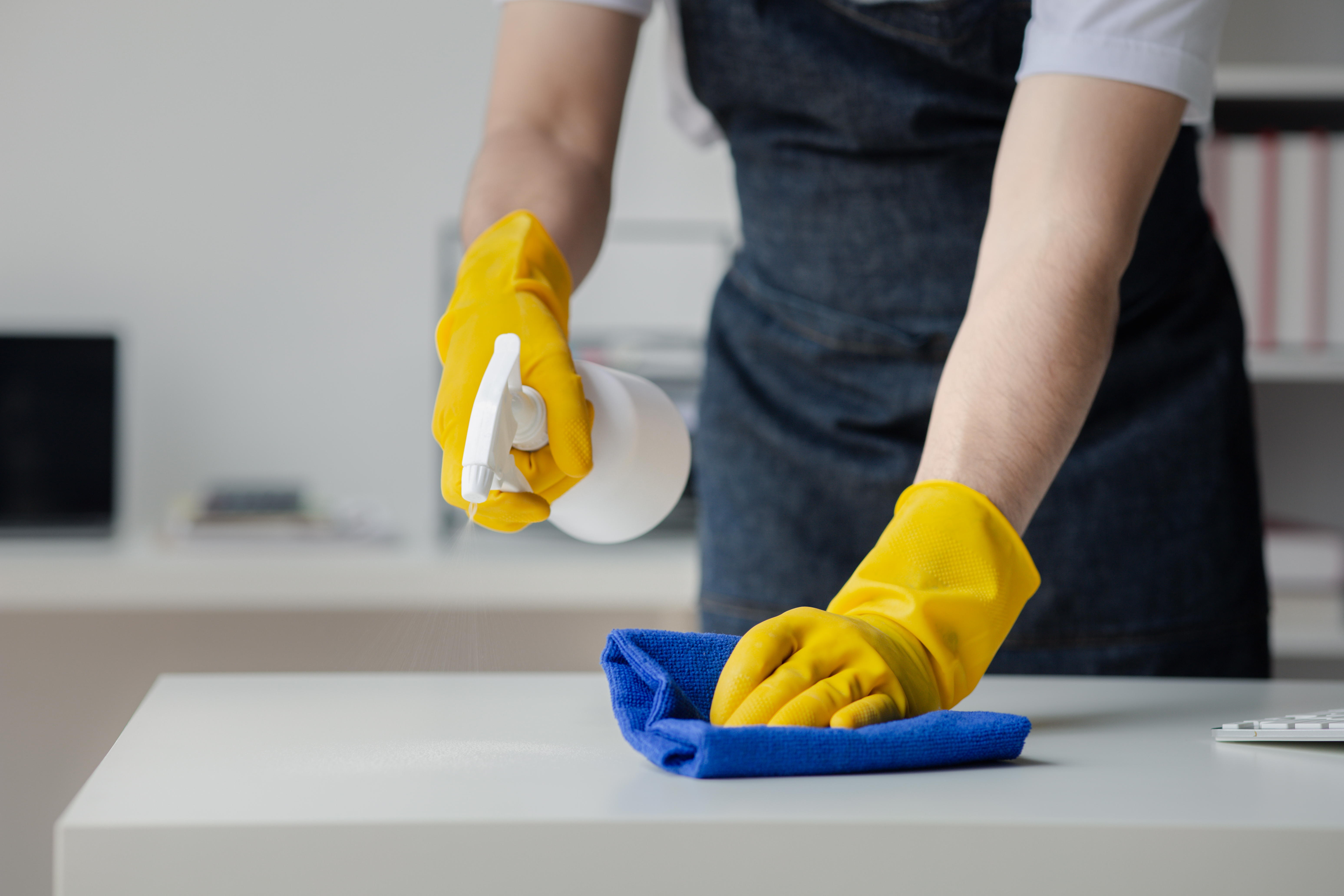 Chemical manufacturing professional handling cleaning product containers in a production environment representing a White Label Chemical Partner service. 
